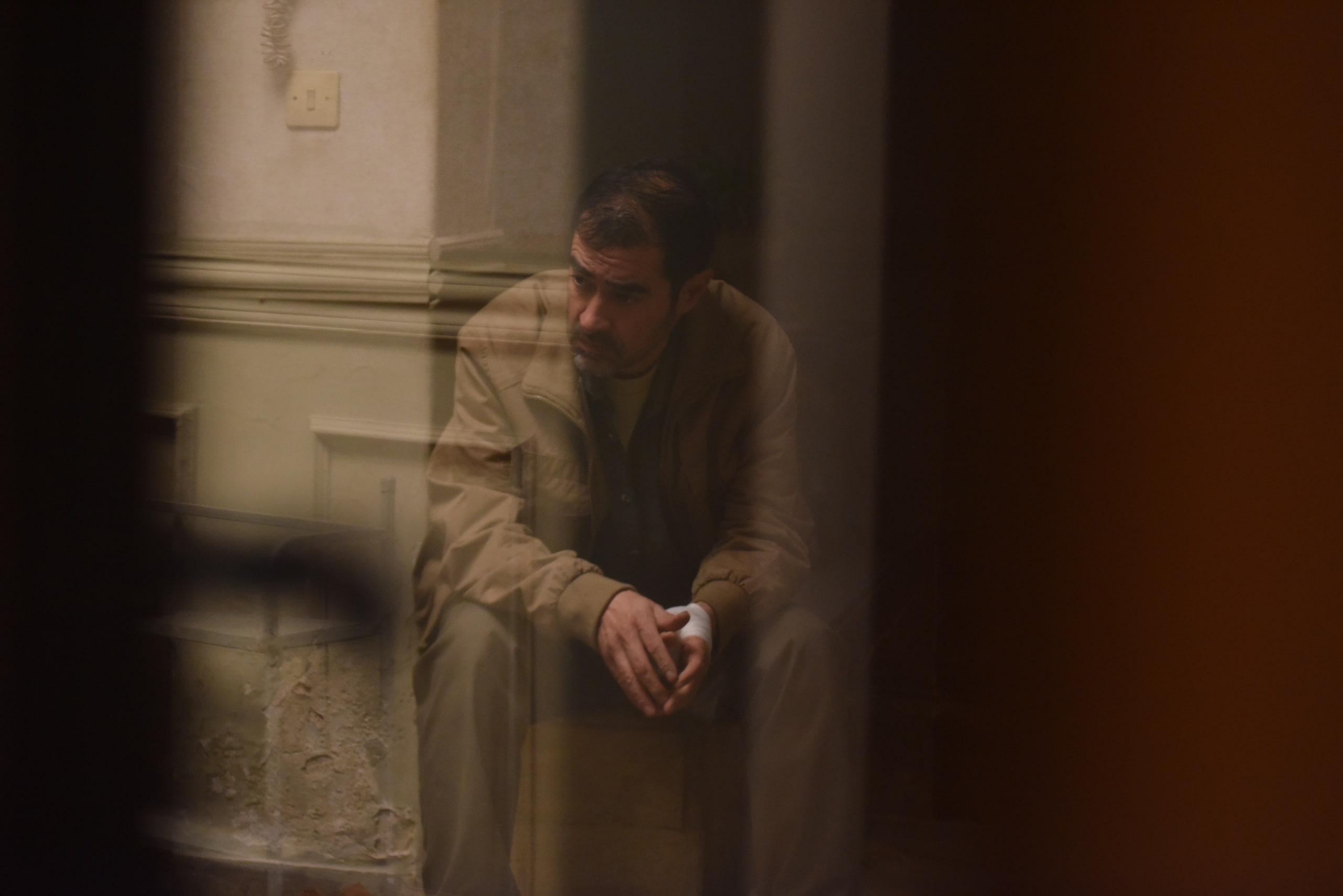 Shahab Hosseini Reflection Shahab Hosseini reflection behind glass